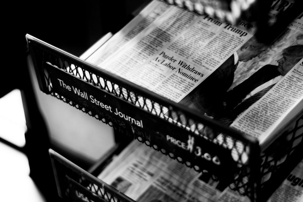 A newsstand displaying newspapers and printed publications