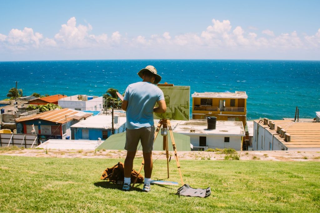 An artist painting outdoors in Old San Juan, facing the coast