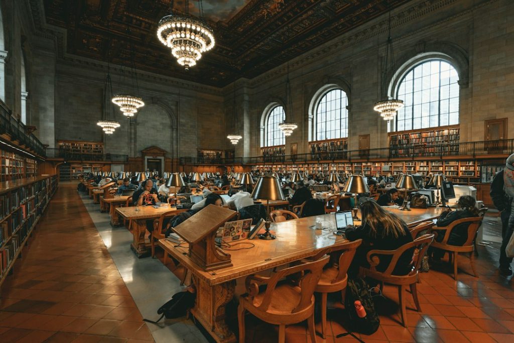 Readers studying inside a public library, illustrating community learning and technology resources