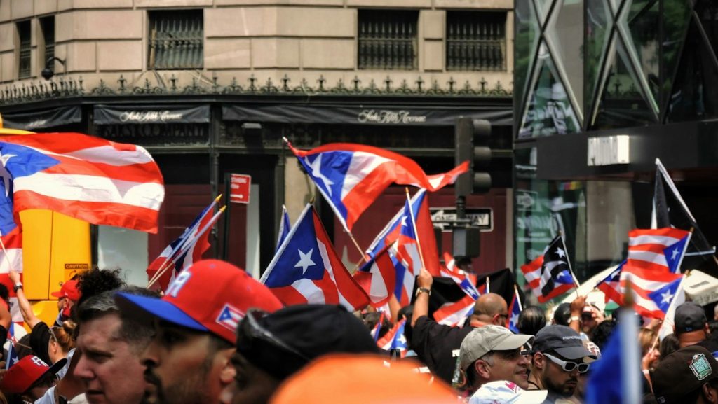 People celebrating Puerto Rican culture and waving Puerto Rican flags at a community gathering