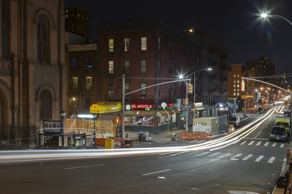 New York neighborhood street with buildings and traffic, suitable for a self-guided cultural walk