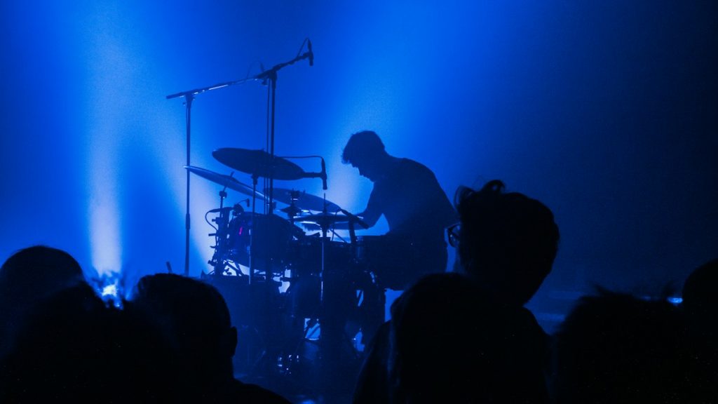 Drummer performing live music for a crowd
